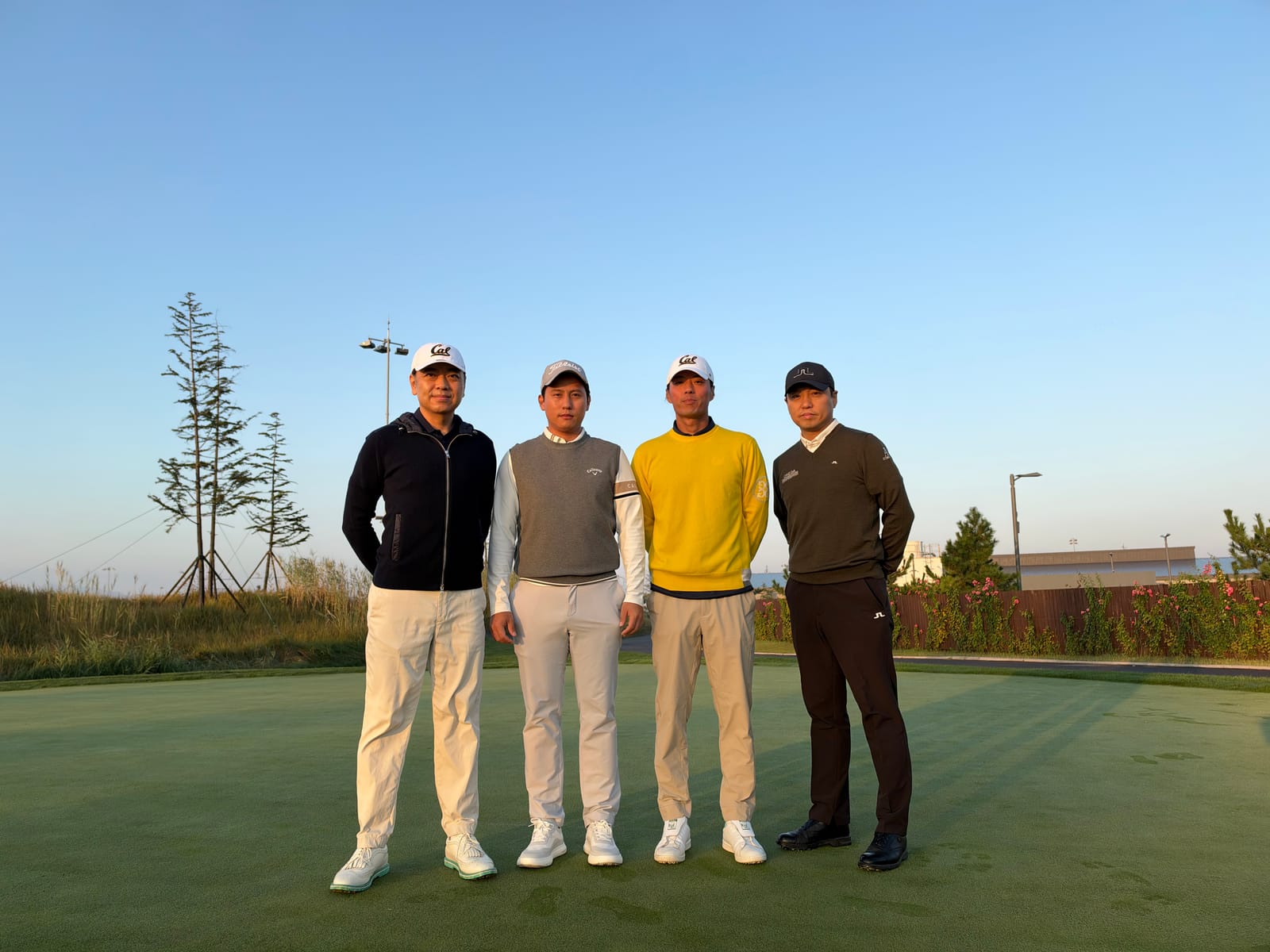 Golfers on the green at sunrise