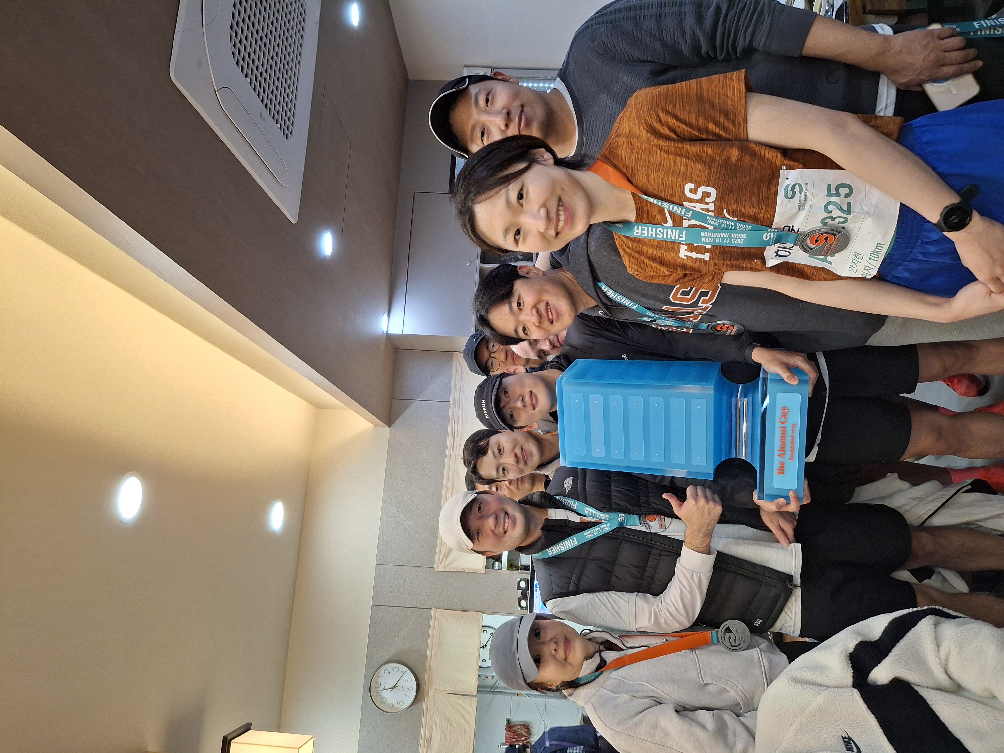 Winning team celebrating with the Alumni Cup trophy